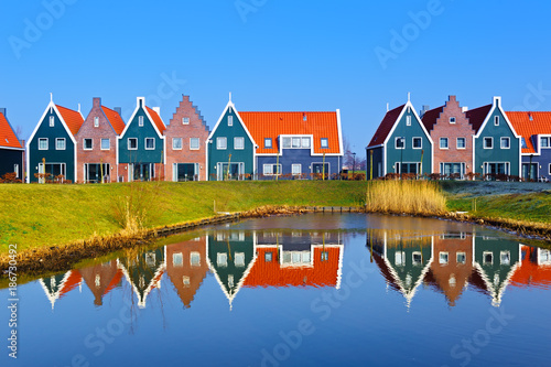 Colored houses of marine  park in Volendam reflected in the water, Netherlands photo