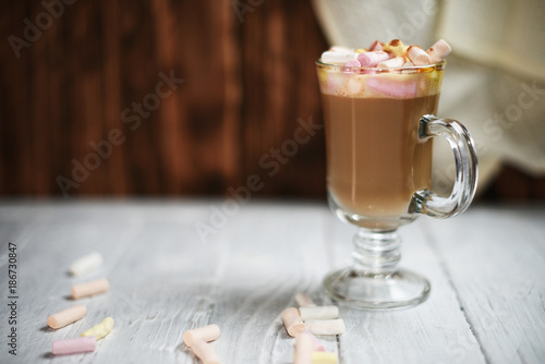 Glass cup of cappuccino on wooden table