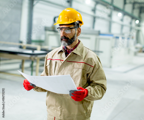 Senior supervisor looking at projest in the factory photo