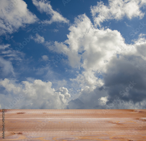 Wallpaper Mural wooden table over blue sky with  clouds Torontodigital.ca