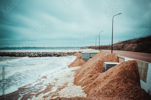 Rose waves during a storm in winter, waves break against rocks photo