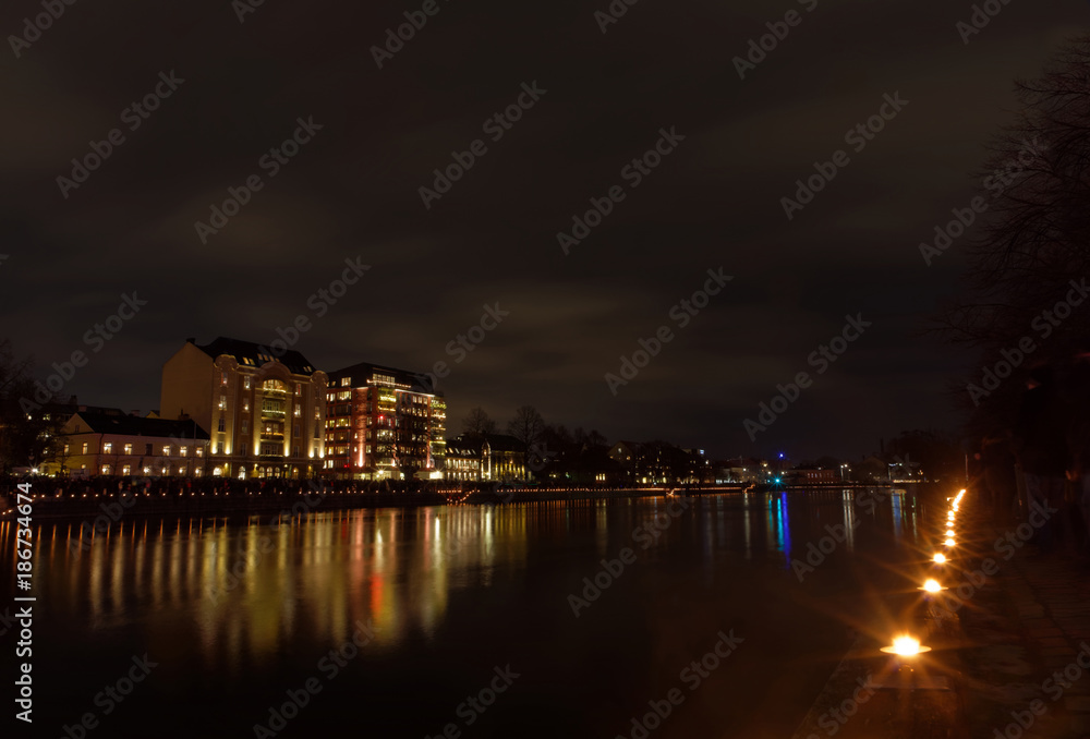 Light festival and the at the river Motala Strom and buildings reflecting in the water during the evening in central Norrkoping in Sweden