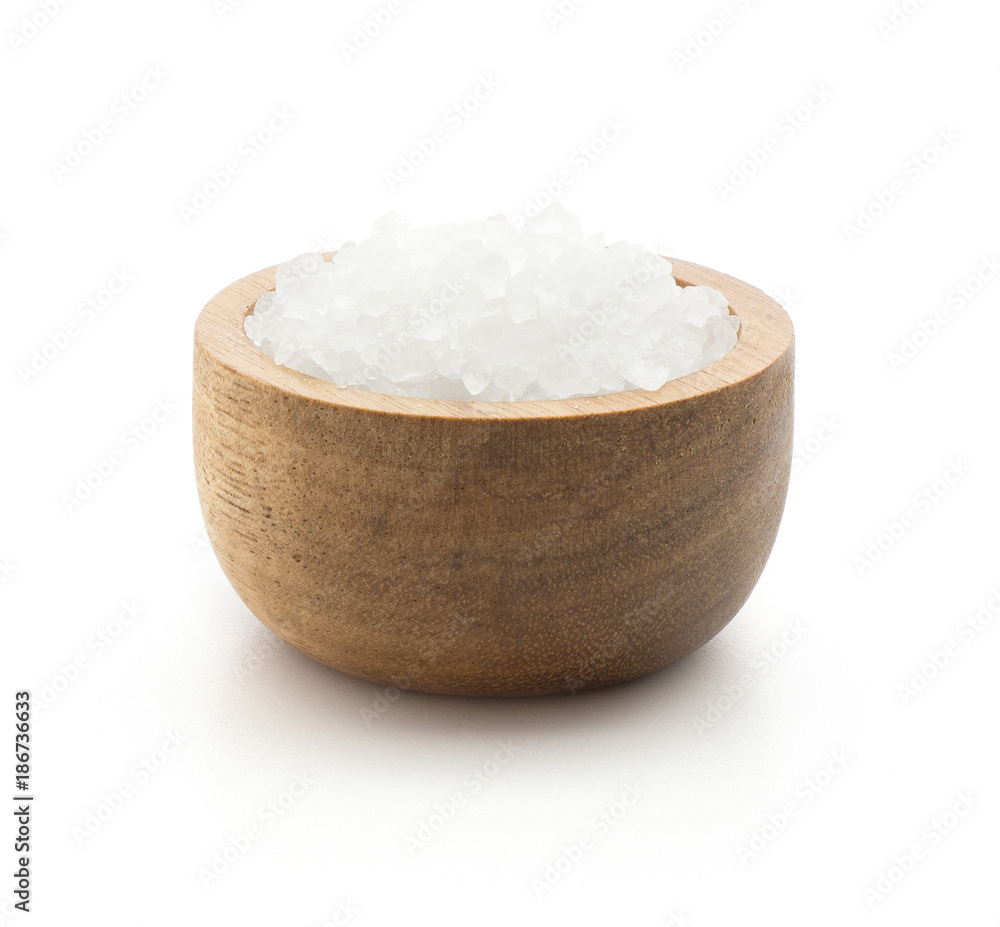 Sea salt in a wood bowl isolated on white background. Sea salt in a wood bowl isolated on white background.