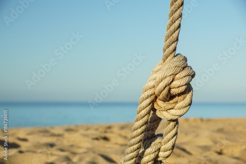 Boat ropes and footprint on sandy beach background