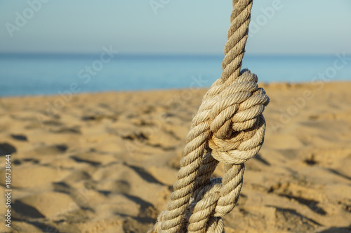 Boat ropes and footprint on sandy beach background