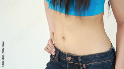 close up waist of woman in blue jeans