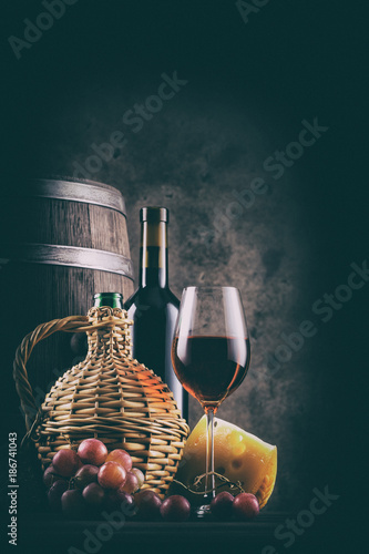 Wine still life with barrel and red wine with grapes