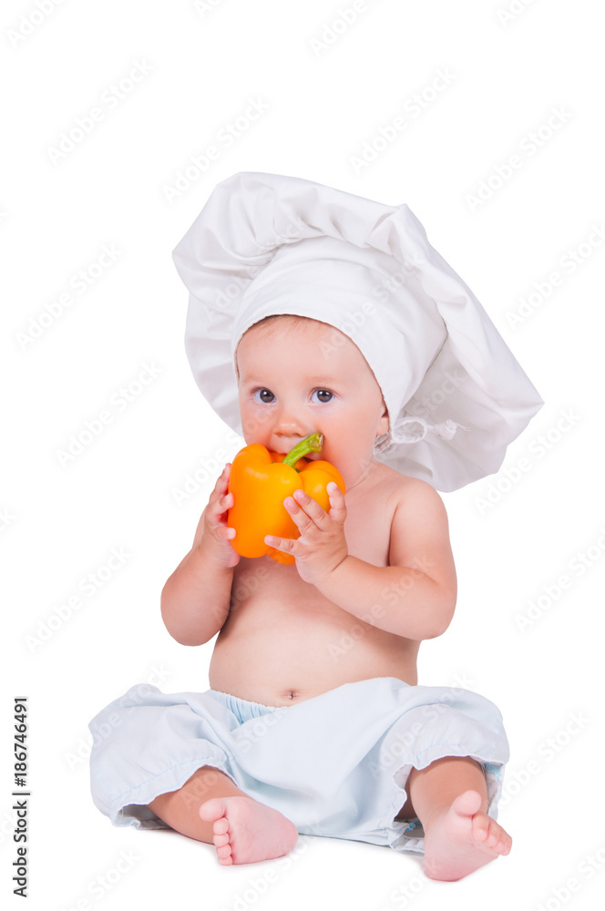 A funny little girl in a chef's clothes is eating pepper. A funny little girl in a chef's clothes is eating pepper.