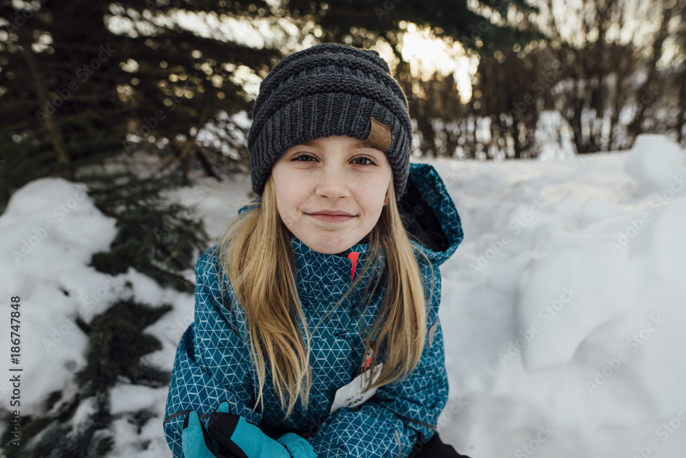 Portrait of girl sitting on snowy field Portrait of girl sitting on snowy field