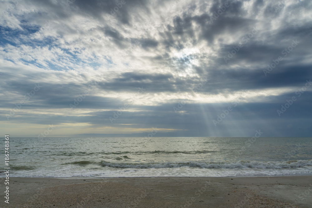 USA, Florida, Spectacular sky and clouds as sunrays shine on the ocean at beach near tampa