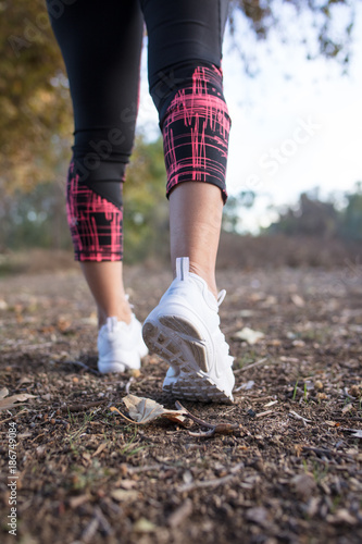 Closeup of woman's legs and feet and shoes walking