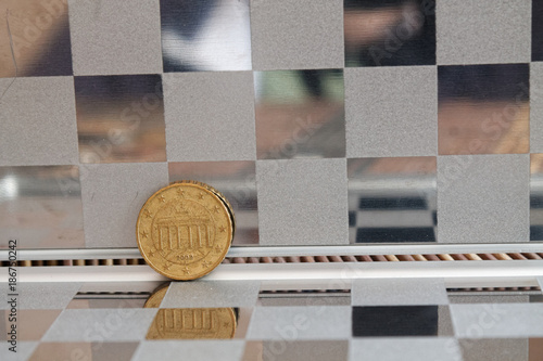 Euro coins in mirror reflect wallet lies on wooden bamboo table background Denomination isten sent - back side photo