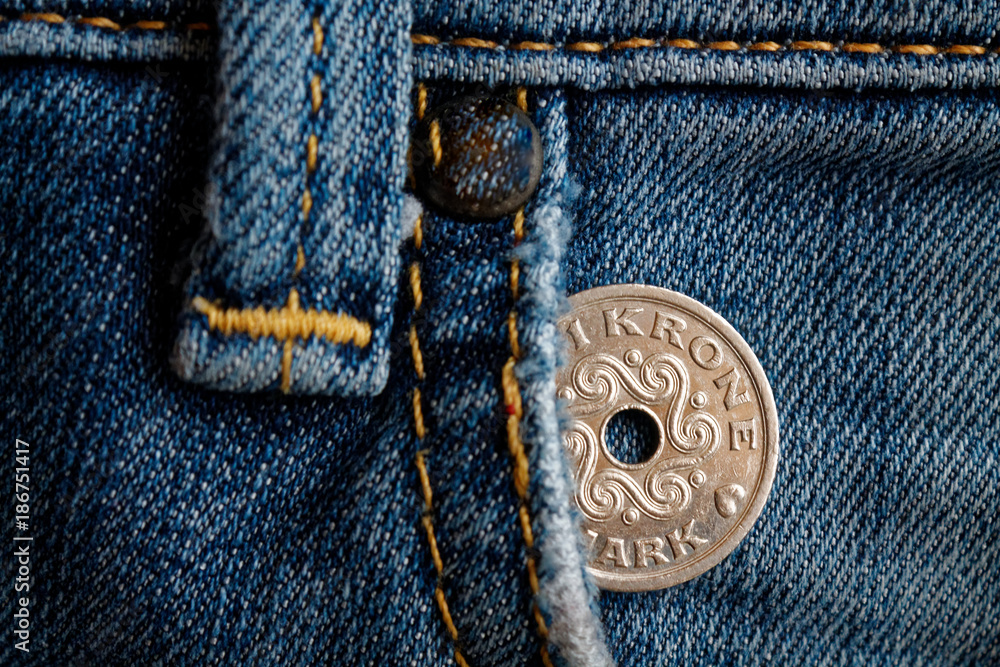 Denmark coin denomination is 1 krone (crown) in the pocket of old worn denim jeans Denmark coin denomination is 1 krone (crown) in the pocket of old worn denim jeans