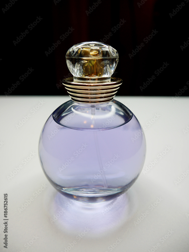 Okrągła buteleczka perfum na białym i czarnym tle Okrągła buteleczka perfum na białym i czarnym tle