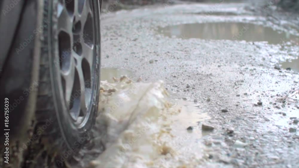 Wheel spinning POV. Close up Slow motion. Dirt, dust, splashes Wheel spinning POV. Close up Slow motion. Dirt, dust, splashes