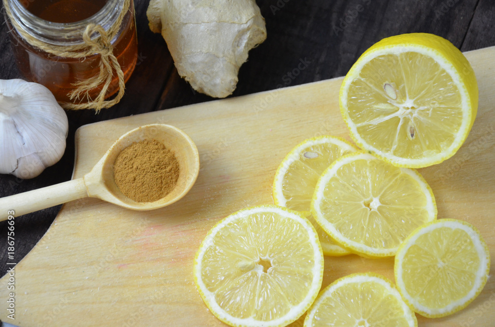 Cup of ginger tea with honey and lemon on wooden table Cup of ginger tea with honey and lemon on wooden table