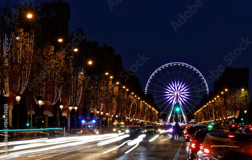 Paris, France - November 25, 2017: Christmas time, the decoration along the Avenue des Champs Elysees and Ferris wheel