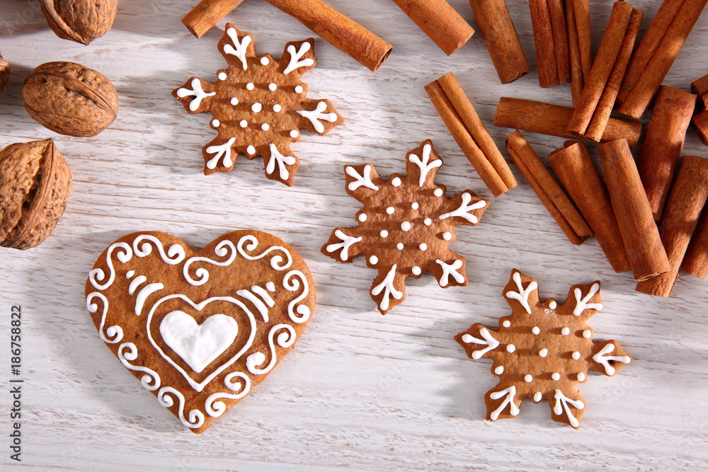 Star and heart made of sweet gingerbread dipped in white icing is a great decoration at the Christmas table.
