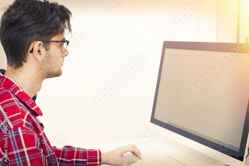 young man with computer at home