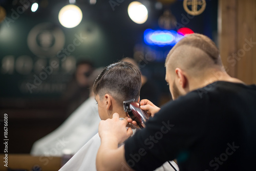 the boy is cut in hairdressing salon photo