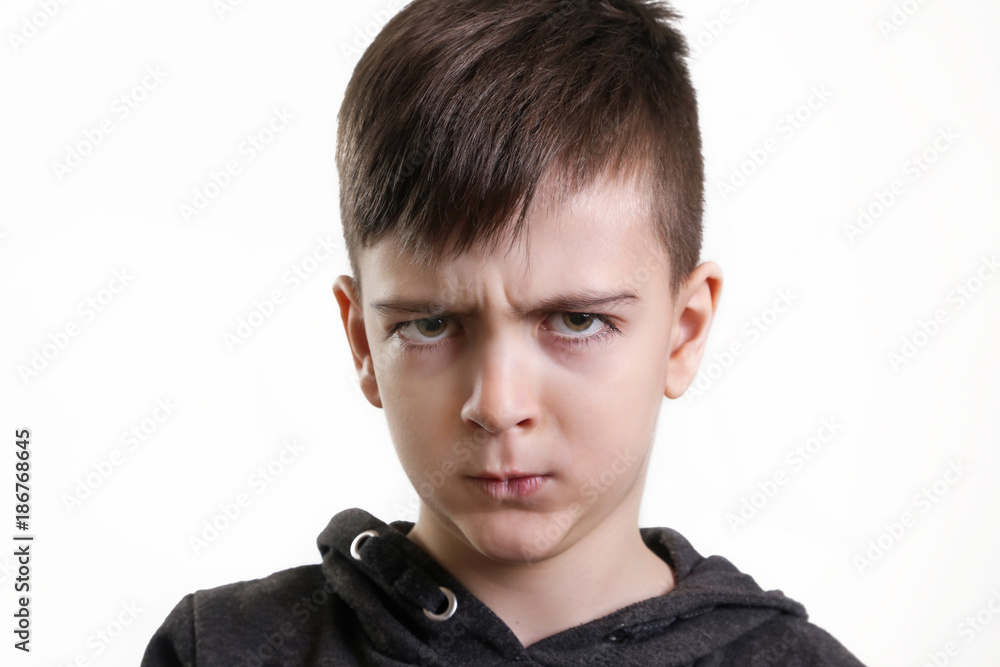 Studio portrait of preschool 5 yerars old boy on the white background - angry facial expression Studio portrait of preschool 5 yerars old boy on the white background - angry facial expression