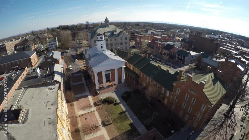 Aerial pushing in to the old historic courthouse over the walking mall in Winchester, VA. Aerial pushing in to the old historic courthouse over the walking mall in Winchester, VA.