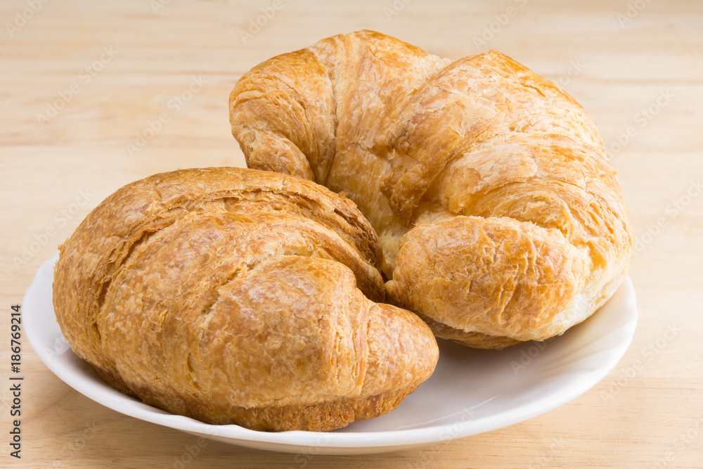 croissants on white dish on wooden table