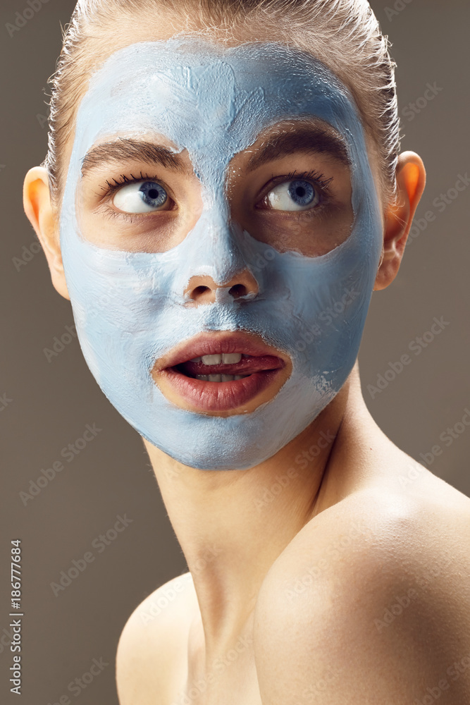 Spa Woman applying mask for face and is surprised Spa Woman applying mask for face and is surprised
