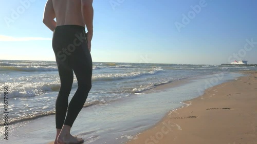 Healthy running man close up on the beach