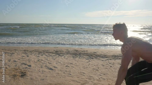 Active man exercising at the beach