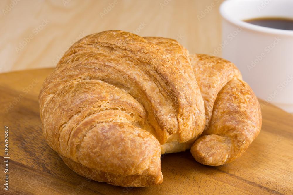 croissant on wooden cutting board croissant on wooden cutting board