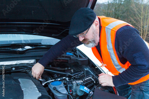 A man has a car breakdown on a country road