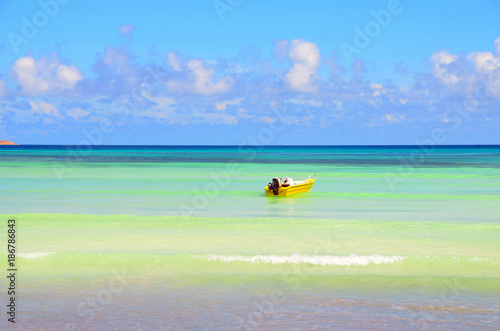 Empty yellow boat in the blue sea