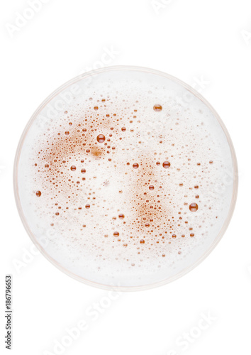Glass of lager ale beer top view with foam