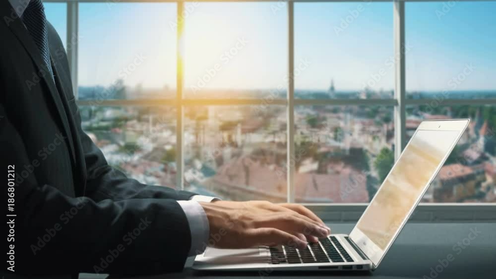 View of Tallinn Estonia.Close up hand Businessman using laptop View of Tallinn Estonia.Close up hand Businessman using laptop