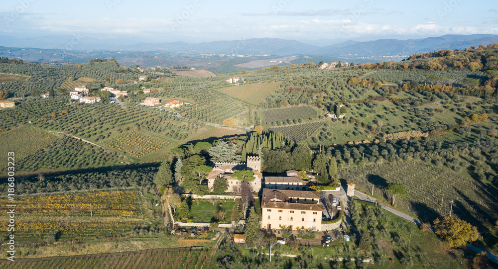 Aerial drone view of a castle in the Tuscan hillside of Italy