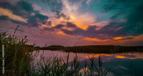 Apocalyptic sunset and clouds over forest lake, timelapse