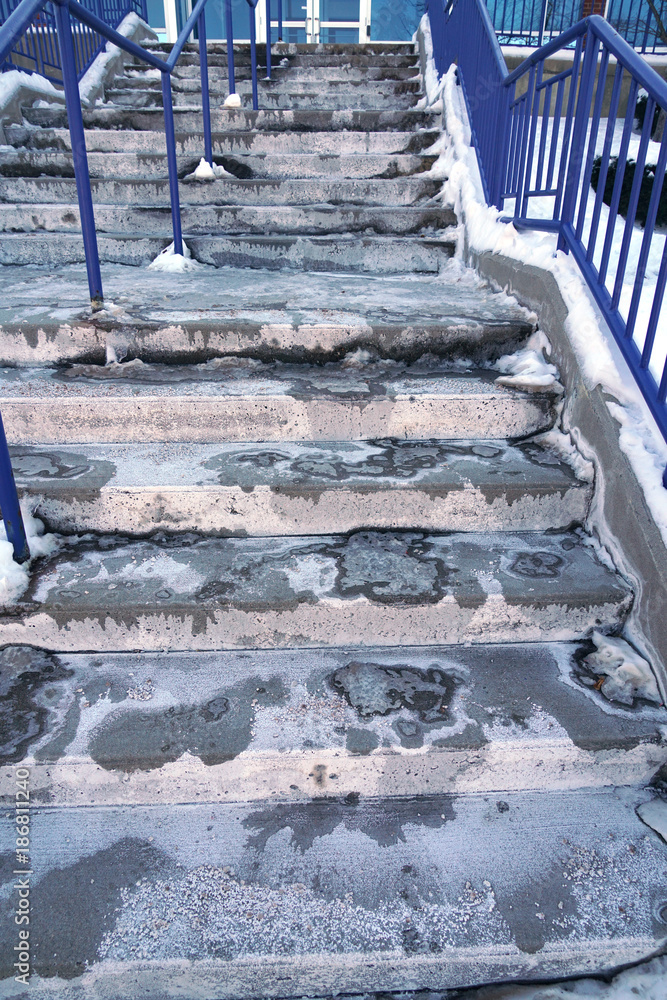 Snow melting salt and ice on the stairs in winter Stock Photo