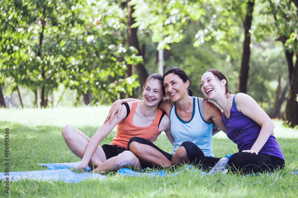 Activities in the family, mother and daughter relaxing in the park after practicing yoga. Activities in the family, mother and daughter relaxing in the park after practicing yoga.