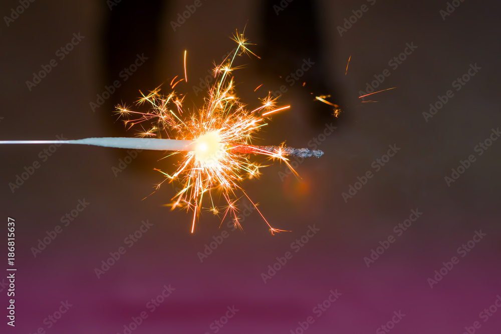 Sparks Bengali festive burning fire in the dark night background, abstract Christmas background