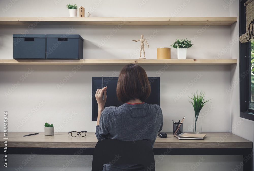 Young woman freelancer with computer in room area, Woman working at the desk, Freelance artist Young woman freelancer with computer in room area, Woman working at the desk, Freelance artist