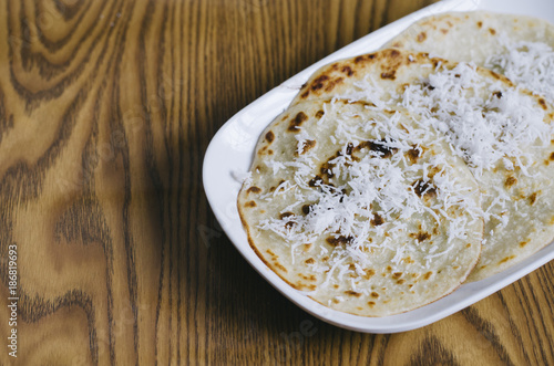 pancake with grated coconut topping in a plate on a white background. Malaysian delicacies photo