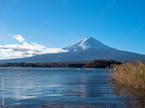 Fuji mountain with the boats and tourist are boating in the lake.