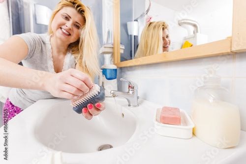 Woman washing her hands in sink