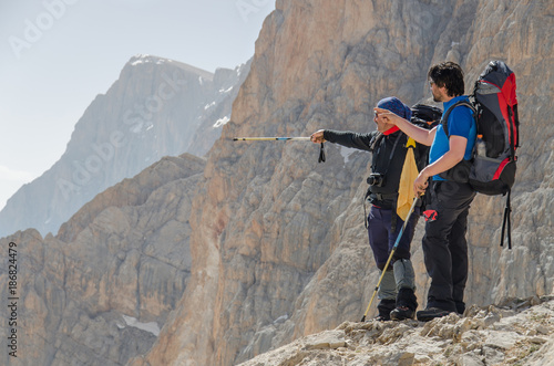 Two mountain climbers are discussing the target peak they will climb on to. Turkey, Central Taurus Mountains, Aladaglar (Anti Taurus).