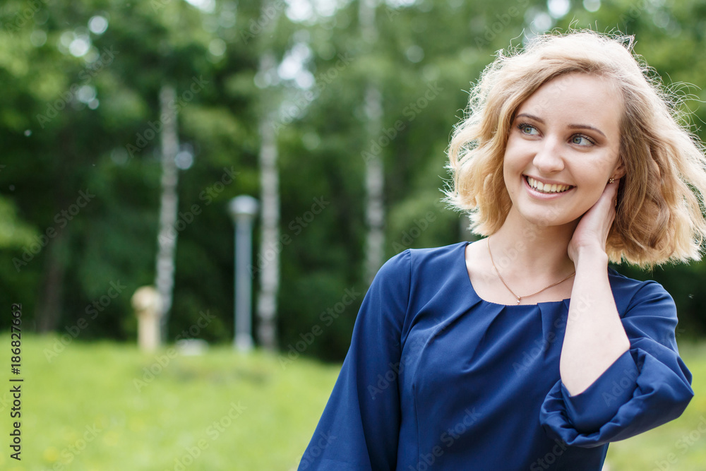 Portrait attractive girl with blond hair in a park Portrait attractive girl with blond hair in a park