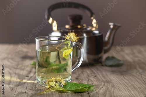 Herbal tea from a linden in a transparent glass mug