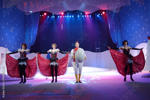 Young actors dancing with a huge chicken egg photo