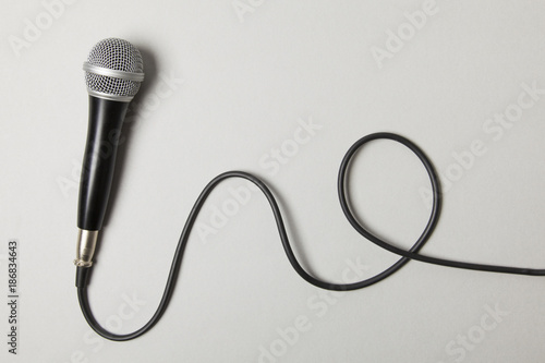 microphone and lead on a plain grey background.