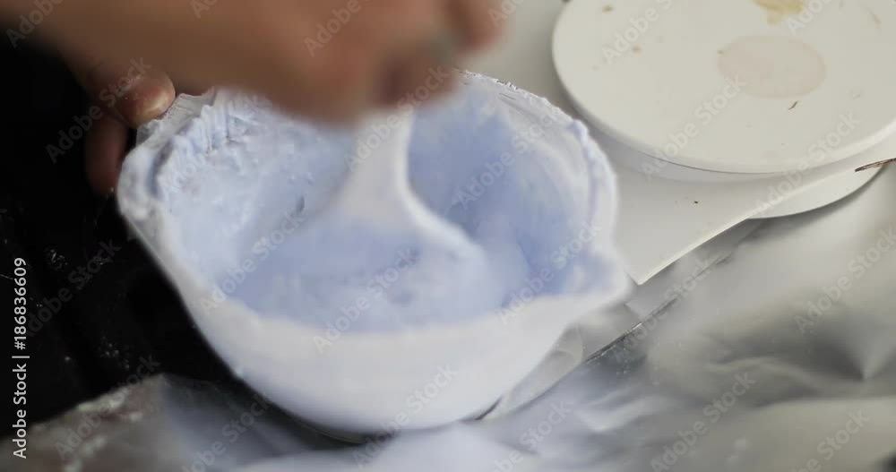 Mixing of hair dye with a brush.